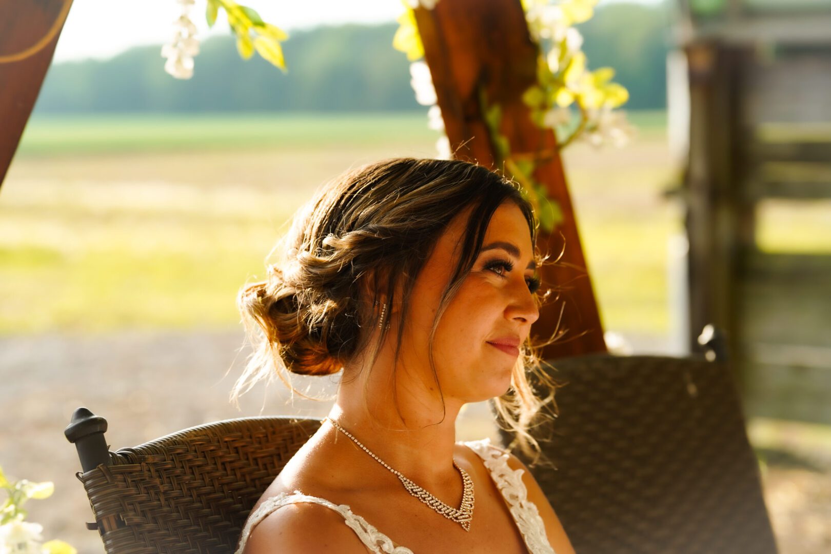 Woman sitting outdoors, smiling softly