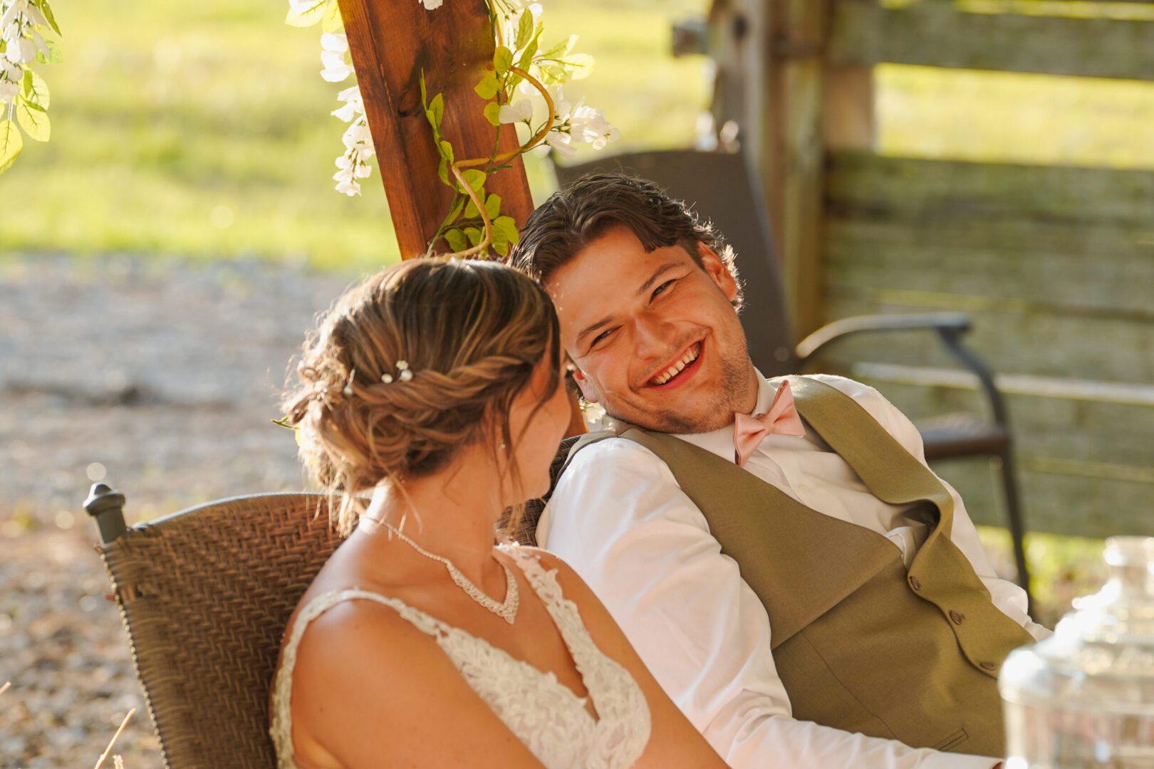 Bride and groom laughing outdoors