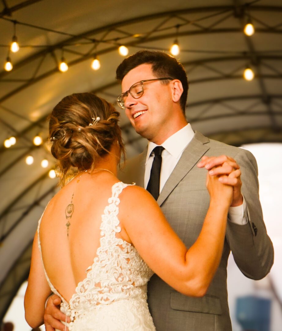 Bride and groom dancing under lights