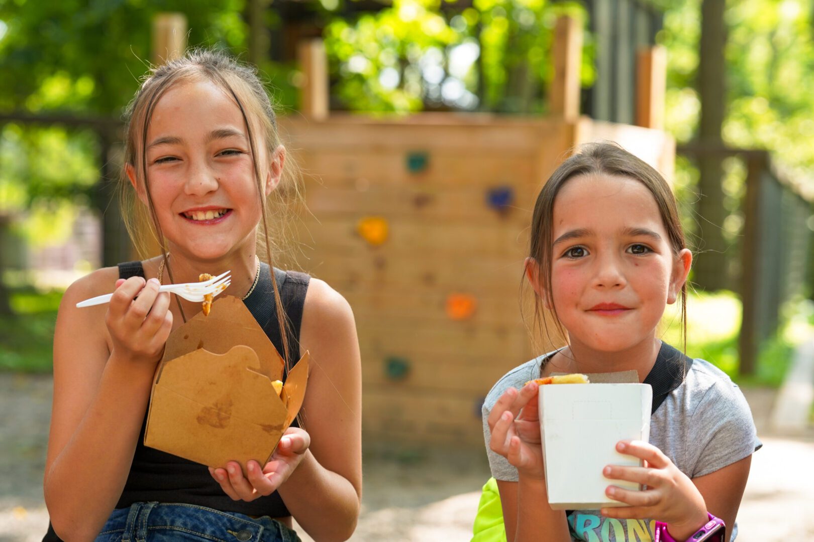 Smiling girls with takeaway food