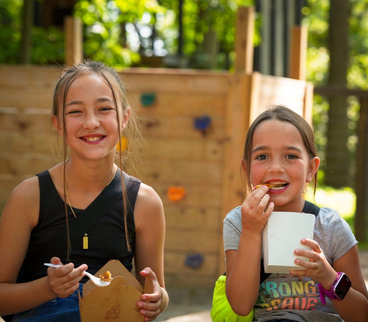 Girls enjoying snacks outdoors