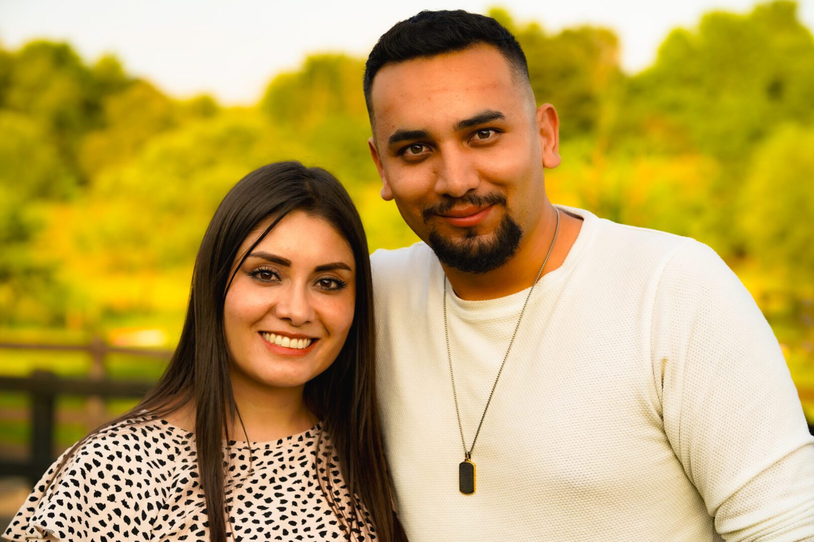 Two people smiling in a park setting