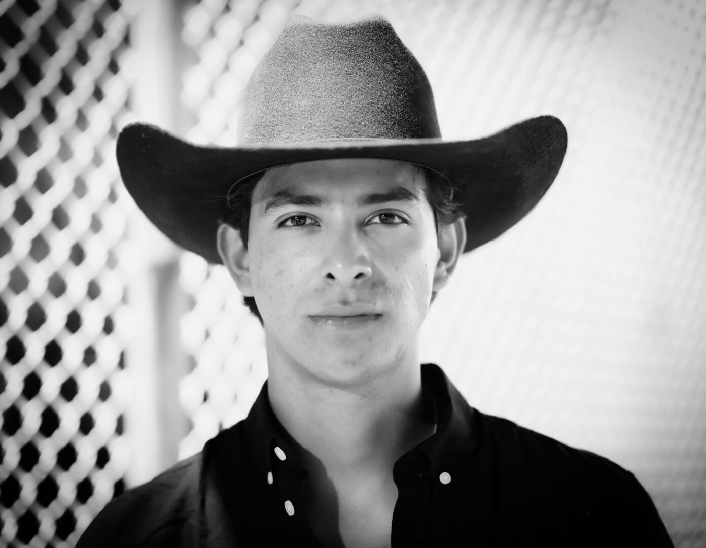 Man wearing cowboy hat, black and white portrait