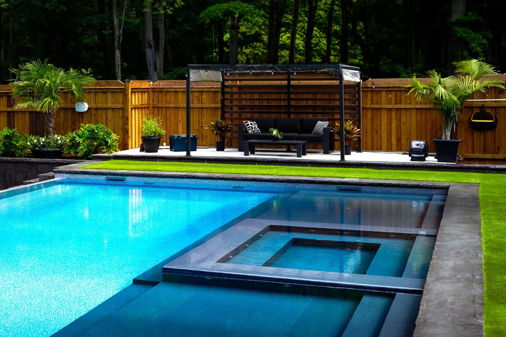 Modern backyard pool with seating area