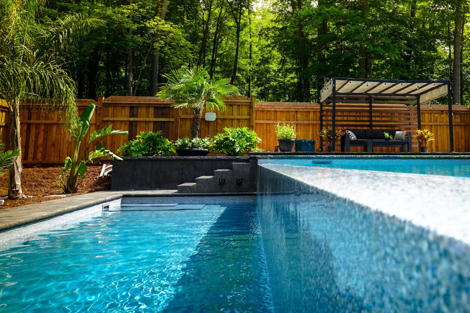 Backyard pool with wooden fence