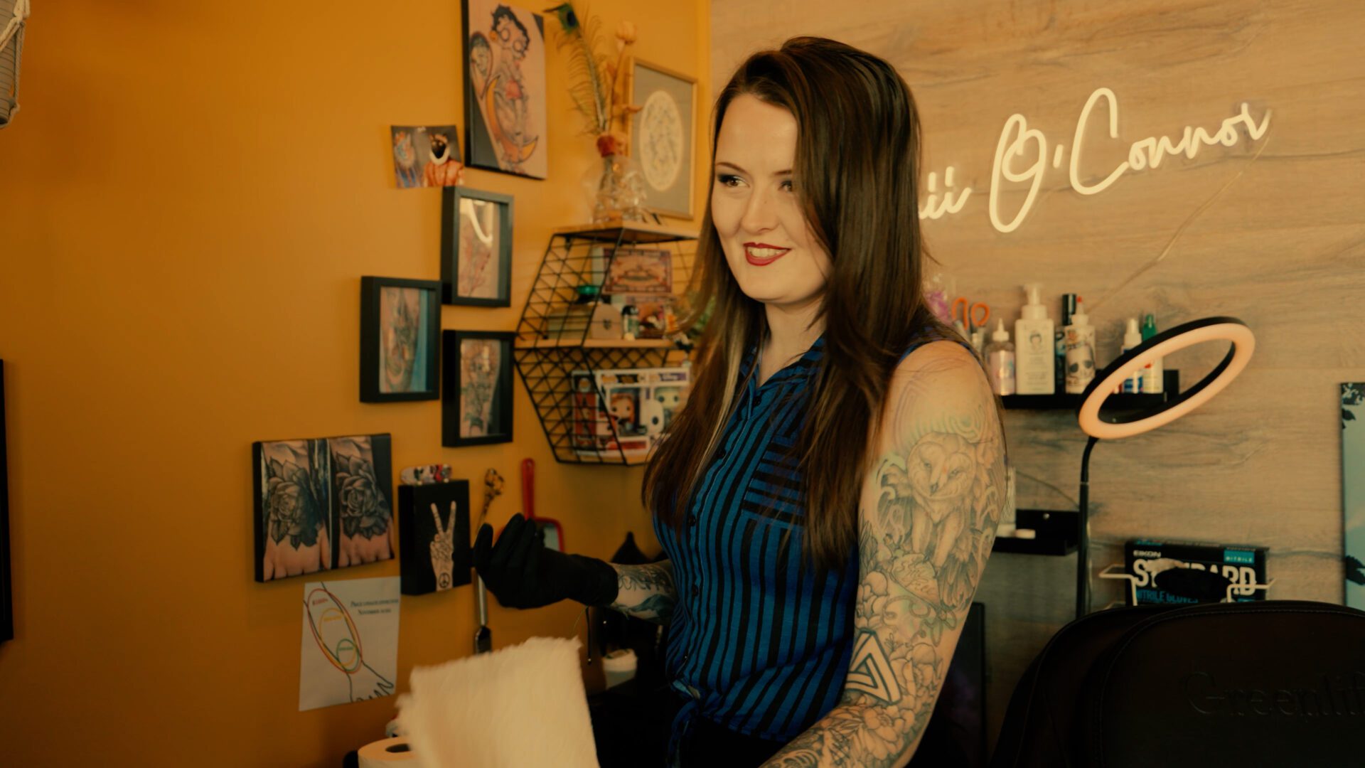 Smiling tattoo artist with arm tattoos